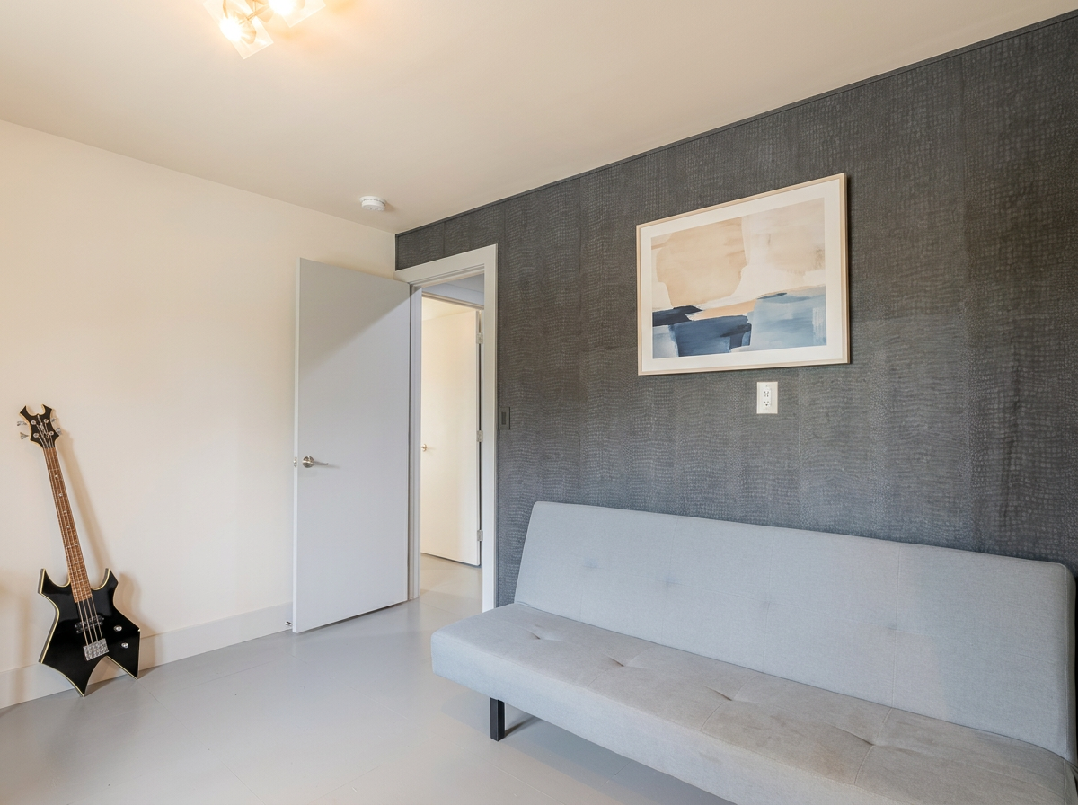 Third bedroom sofa bed against textured accent wall